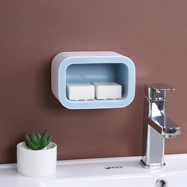 Elegant two-tone wall-mounted soap holders with separate compartments for soap bars and extra storage for compact bathrooms.